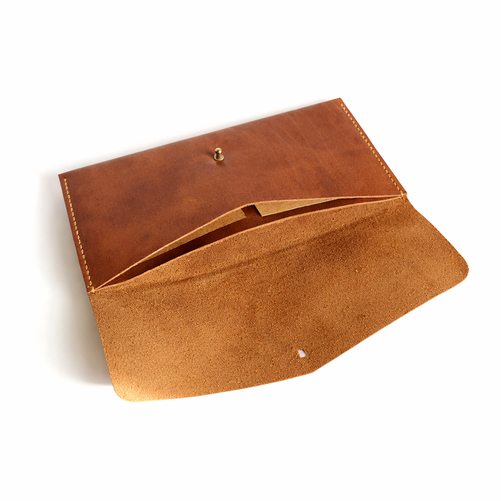 Brown leather clutch on a white background