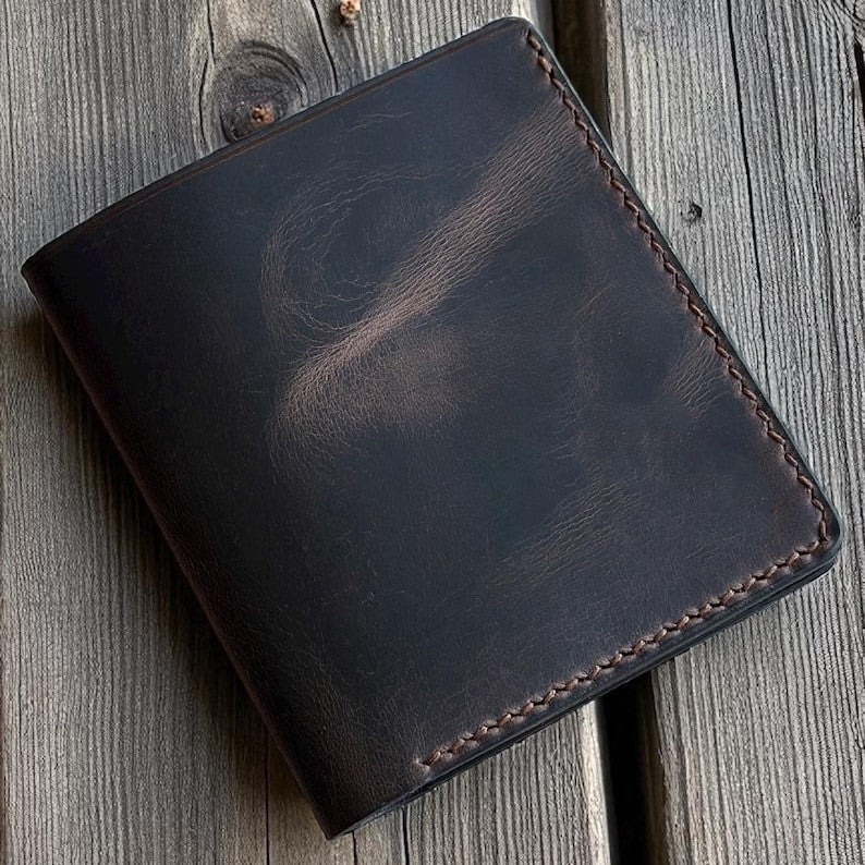 Brown leather wallet on a wooden surface