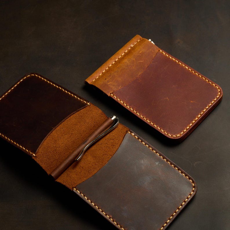 Two brown leather wallets 