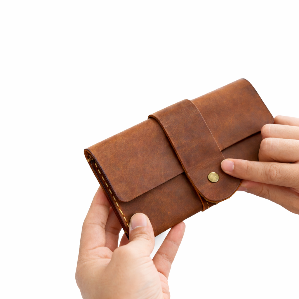 Brown leather wallet held by hands on a white background